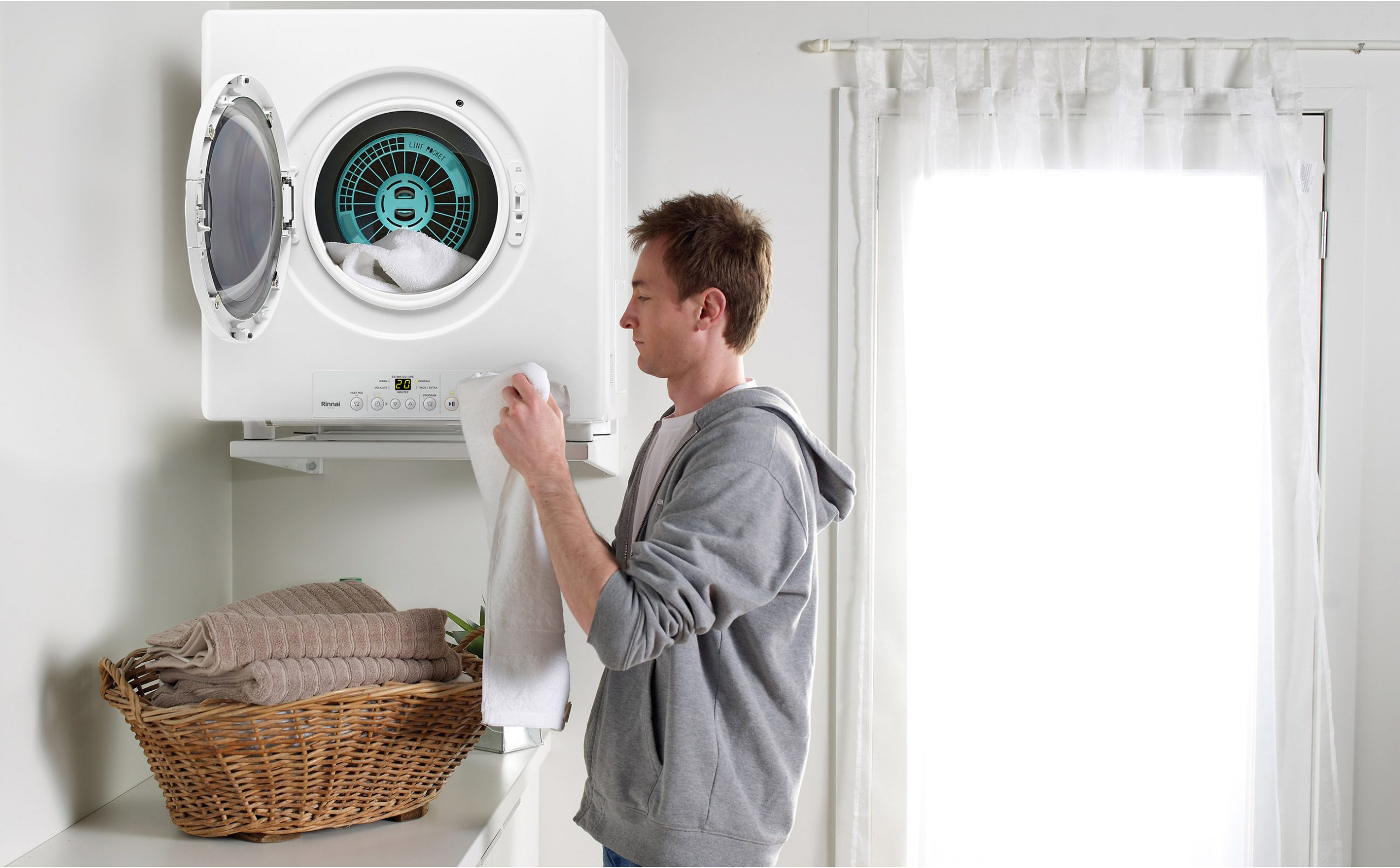 Rinnai Dry-Soft Gas Clothes Dryer (lifestyle - man side on door open)