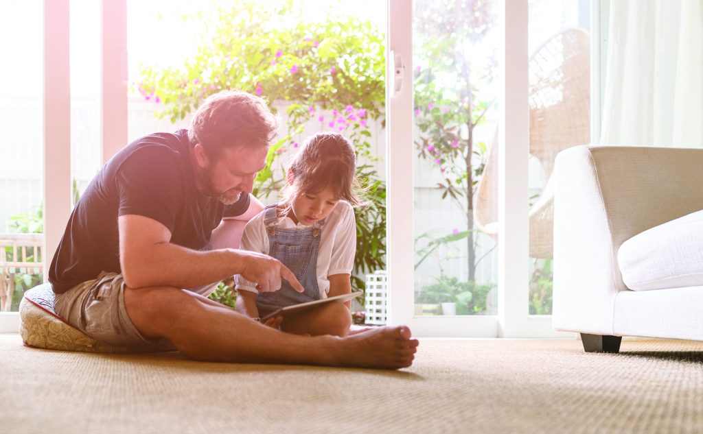 Rinnai C Series Evaporative Air Cooler. Father and daughter looking at digital tablet.