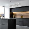 Inverter Multi - Slim Ducted above black and wooden kitchen island, Side view of a panoramic black and wooden kitchen interior with black countertops and an island. 3d rendering mock up