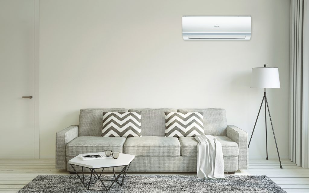 rinnai air conditioner above a grey sofa